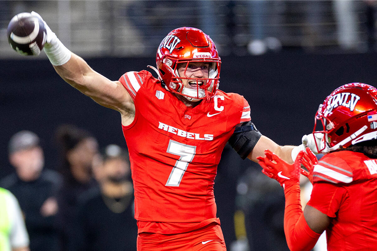 UNLV linebacker Jackson Woodard (7) celebrates after scooping a fumble and scoring a touchdown ...