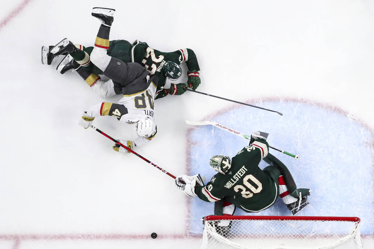 Vegas Golden Knights center Tomas Hertl (48) and Minnesota Wild center Marco Rossi (23) collide ...