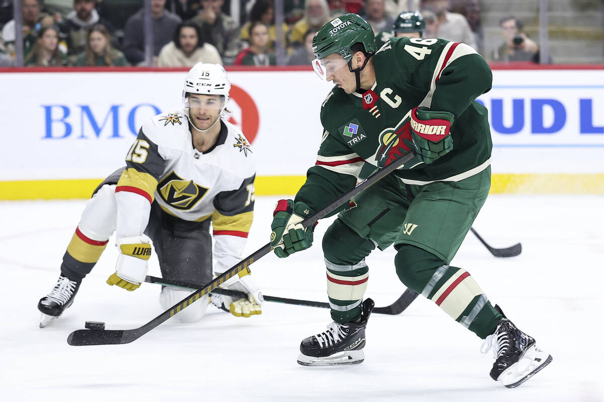 Minnesota Wild defenseman Jared Spurgeon, right, shoots as Vegas Golden Knights defenseman Noah ...