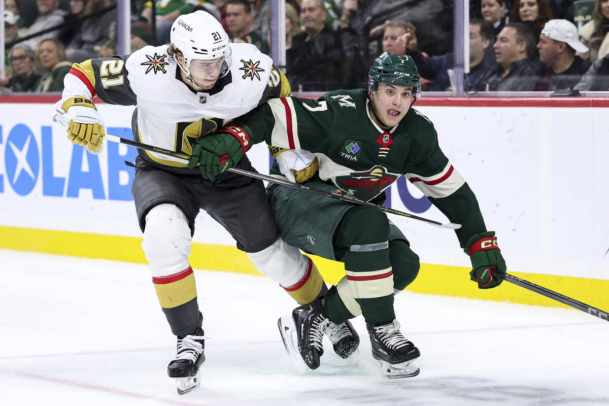 Vegas Golden Knights center Brett Howden, left, and Minnesota Wild defenseman Brock Faber compe ...