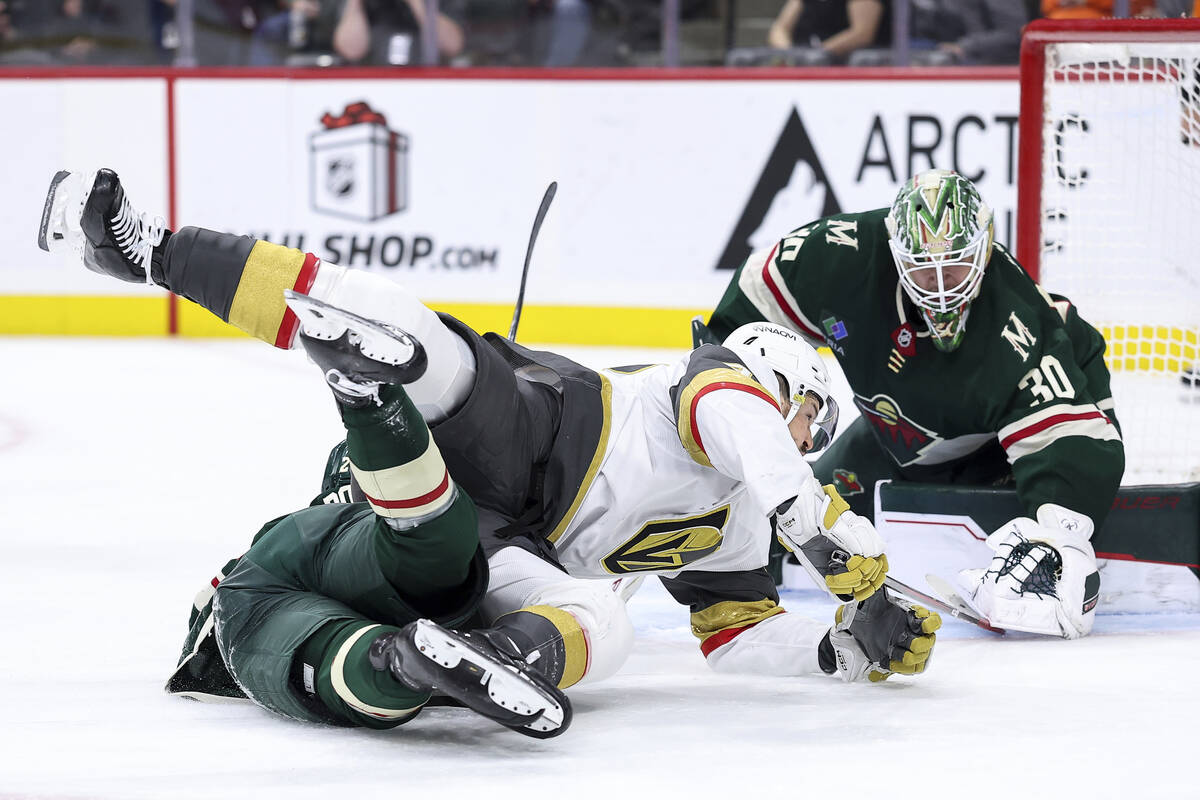 Vegas Golden Knights center Tomas Hertl (48) and Minnesota Wild center Marco Rossi (23) collide ...