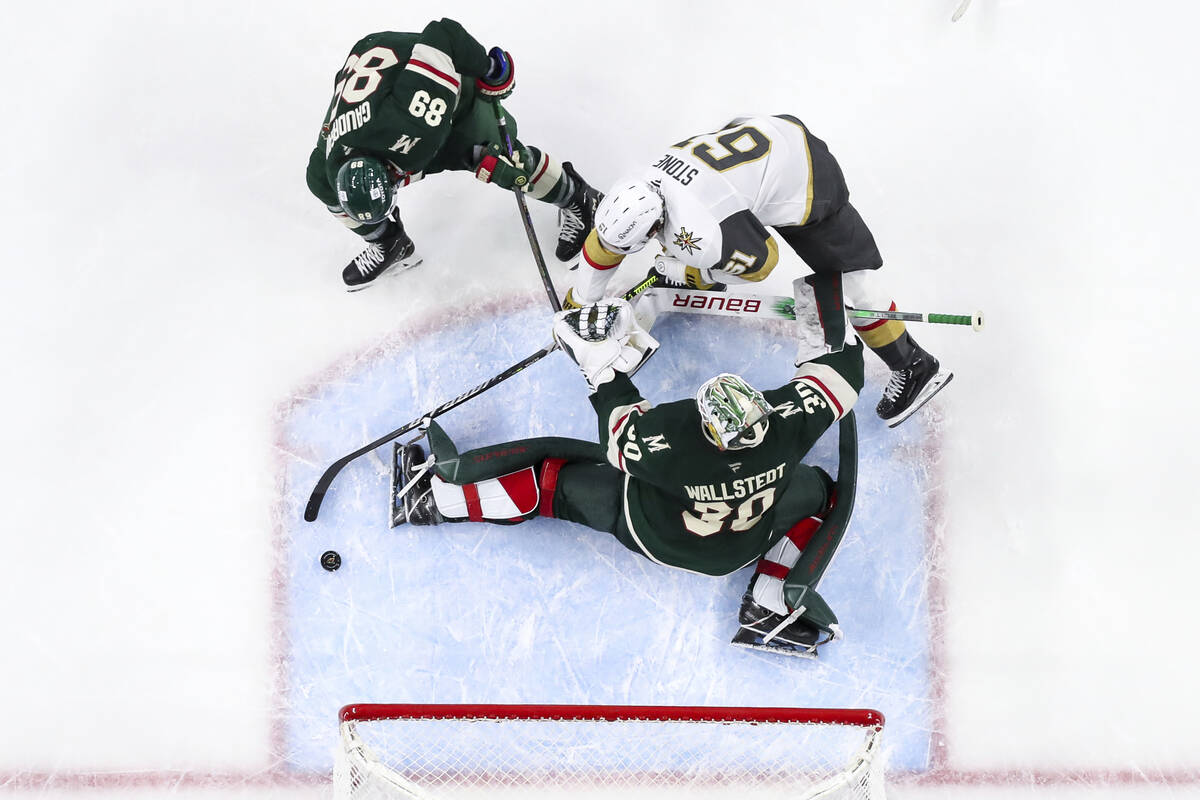 Vegas Golden Knights right wing Mark Stone (61) attempts to shoot as Minnesota Wild goaltender ...