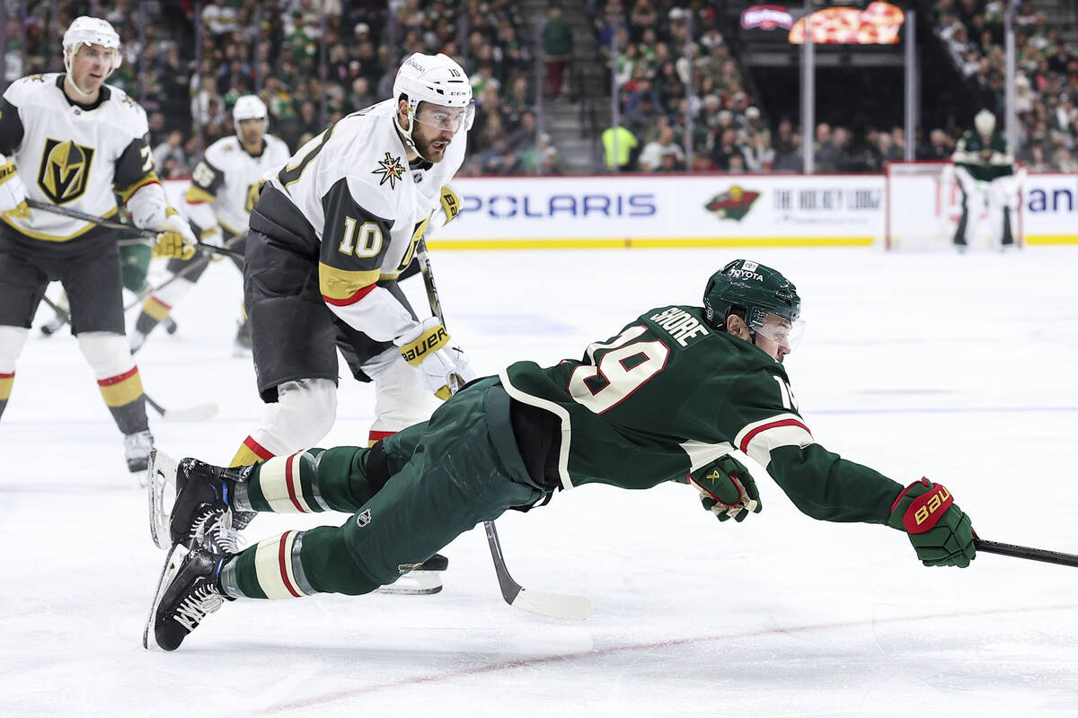 Minnesota Wild center Devin Shore (19) dives for the puck as Vegas Golden Knights center Nicola ...