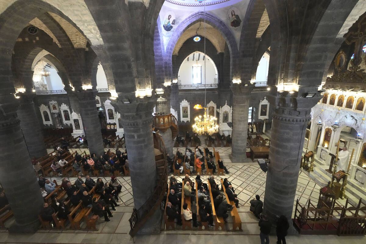 Syrian attend the first Sunday Mass since Syrian President Bashar Assad's ouster, at Mariamiya ...