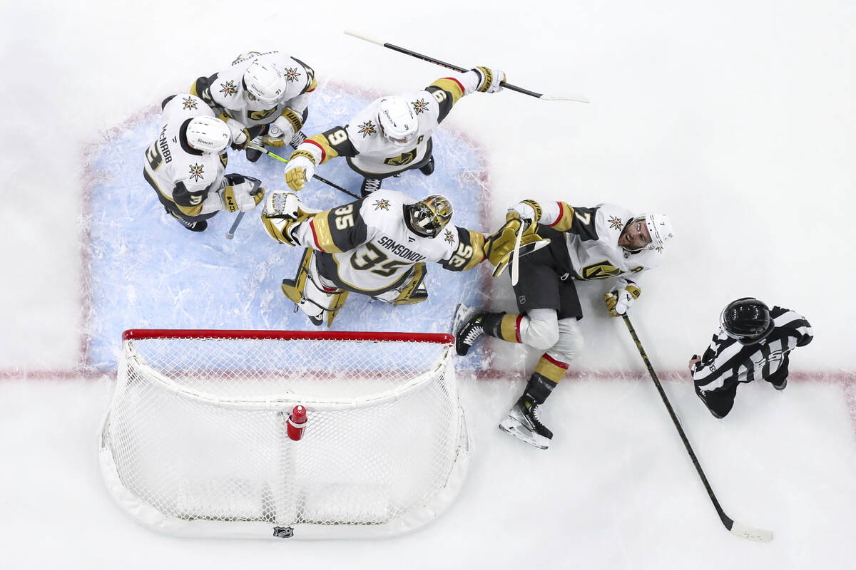 Vegas Golden Knights players celebrate after their win aover the Minnesota Wild in an NHL hocke ...