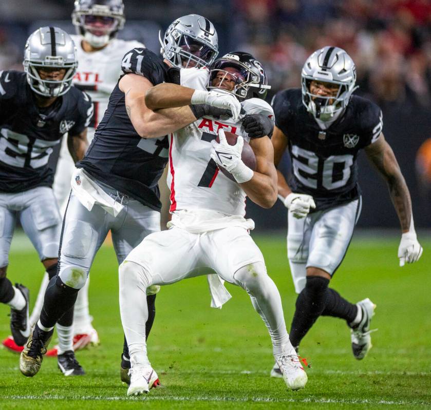 Atlanta Falcons running back Bijan Robinson (7) is driven back for a tackle by Raiders lineback ...