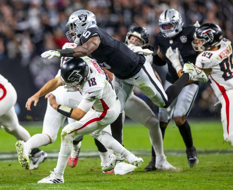 Atlanta Falcons quarterback Kirk Cousins (18) is taken down after a rushed pass by Raiders line ...