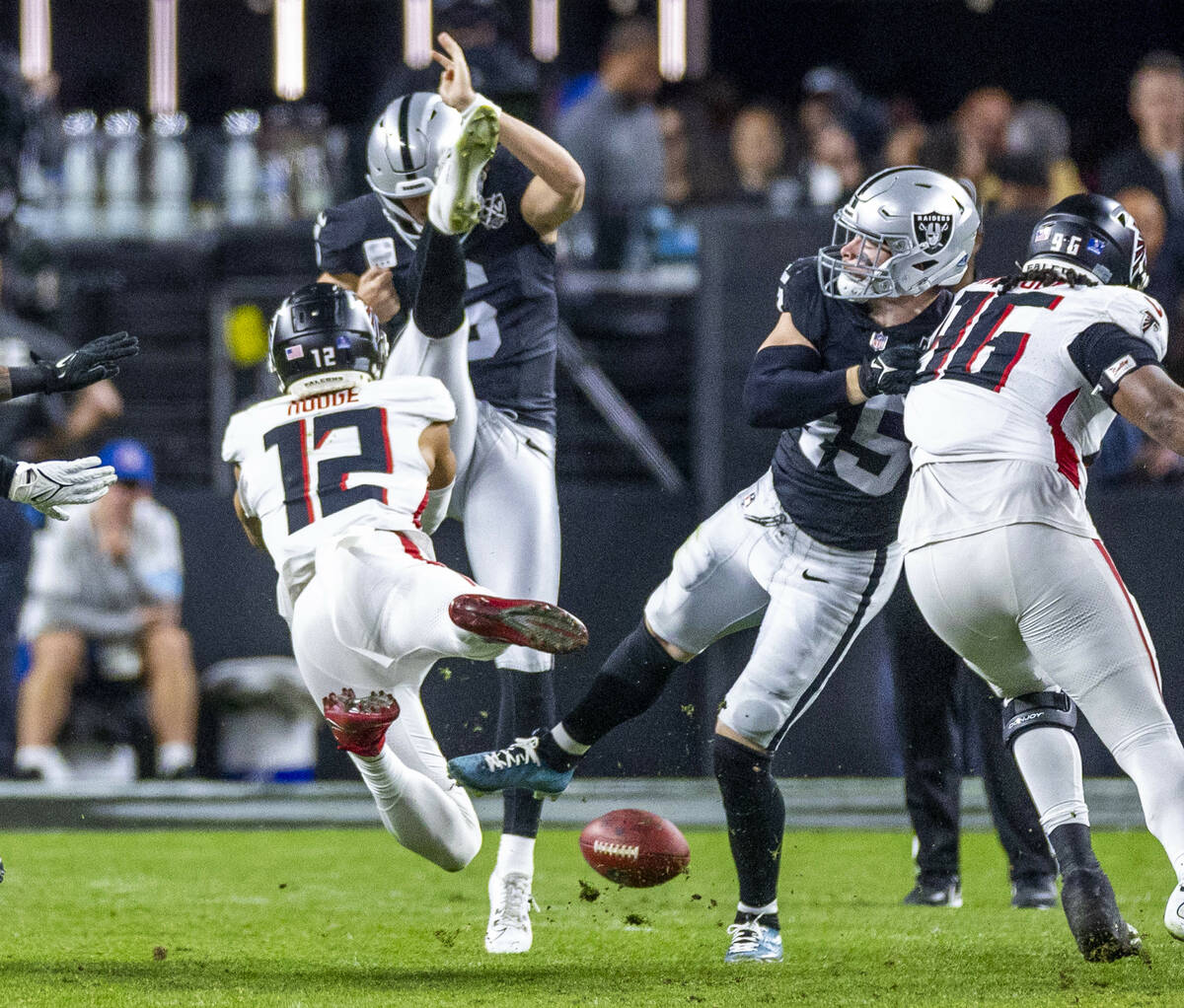 Atlanta Falcons wide receiver KhaDarel Hodge (12) blocks a punt attempt by Raiders punter AJ Co ...