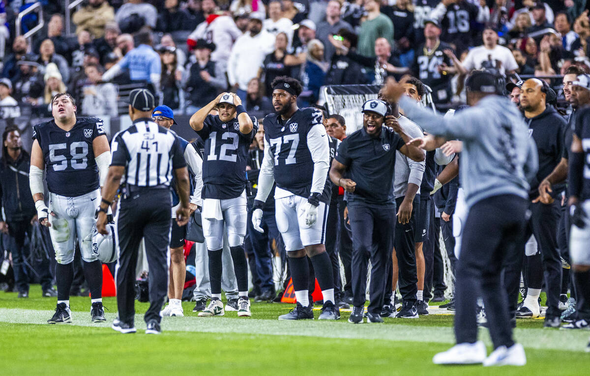 The Raiders sideline is visibly upset by a roughing the passer call against Raiders linebacker ...