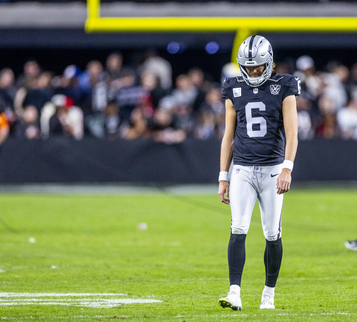 Raiders punter AJ Cole (6) walks off the field dejected after a loss to the Atlanta Falcons dur ...