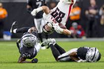 Raiders cornerback Nate Hobbs, left, and safety Isaiah Pola-Mao, right, flip Atlanta Falcons ti ...