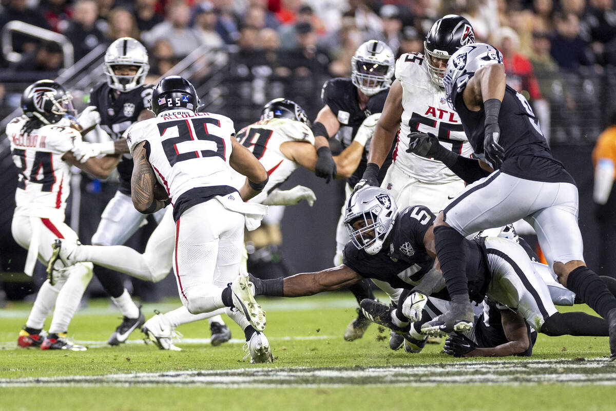 Raiders linebacker Divine Deablo (5) dives after Atlanta Falcons running back Tyler Allgeier (2 ...