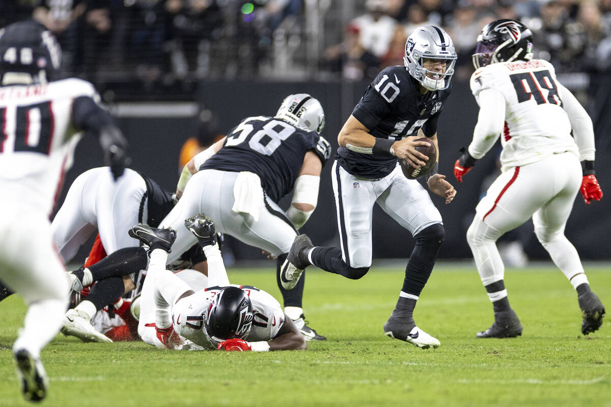 Raiders quarterback Desmond Ridder (10) runs with the ball during the first half of the NFL gam ...