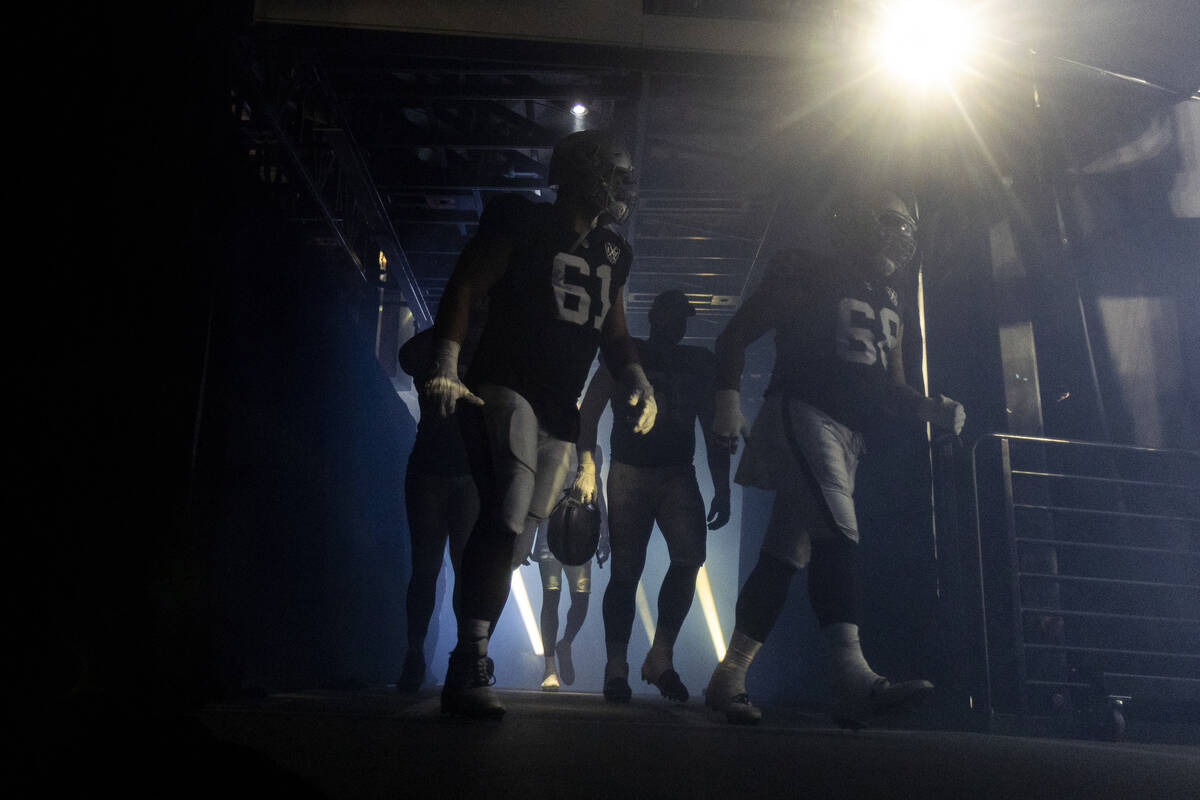 Raiders players run out of the entrance tunnel before the NFL game against the Atlanta Falcons ...