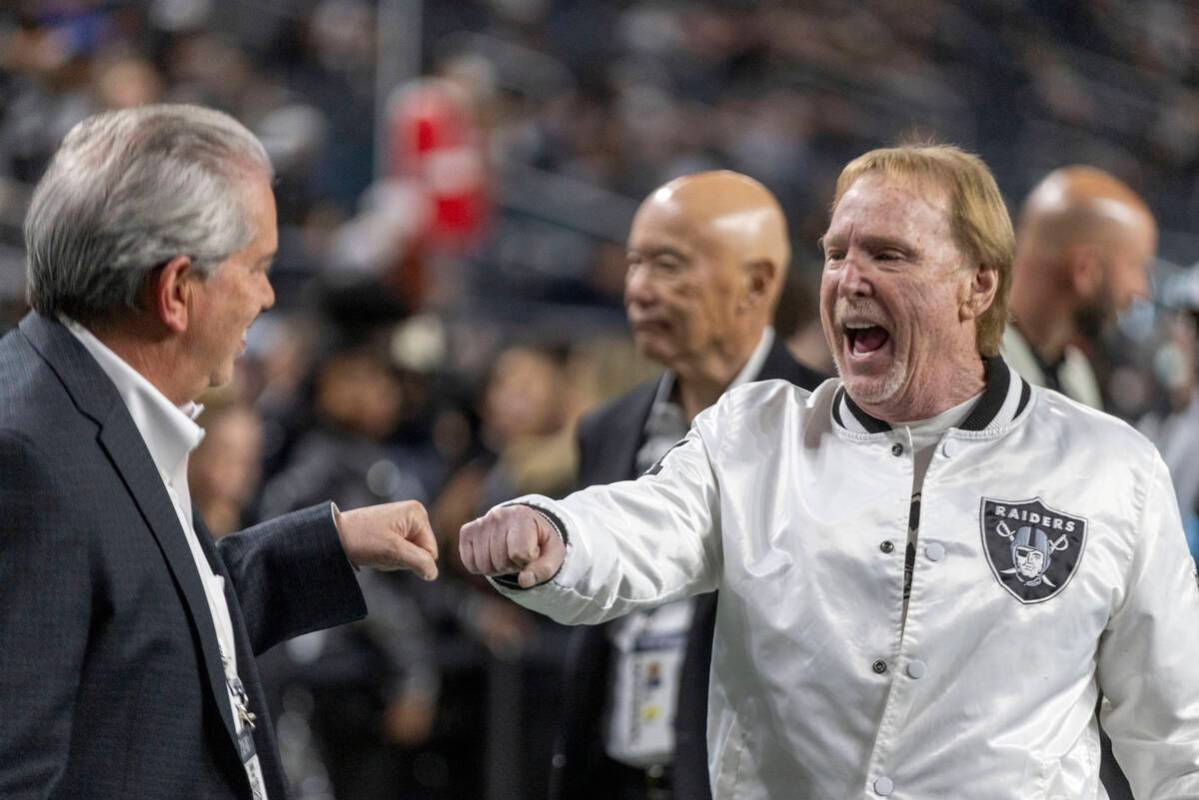 Raiders owner Mark Davis, right, greets an attendee before the start of an NFL game against the ...