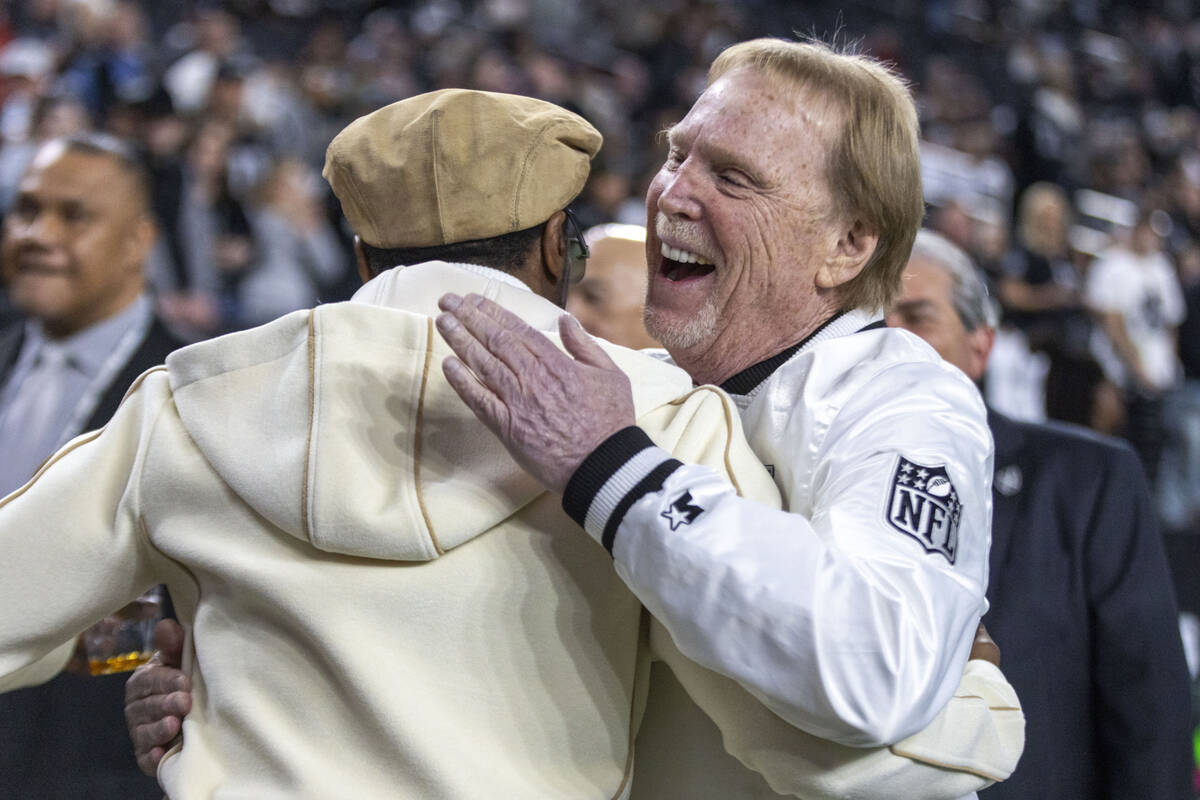 Raiders owner Mark Davis, right, greets an attendee before the start of an NFL game against the ...