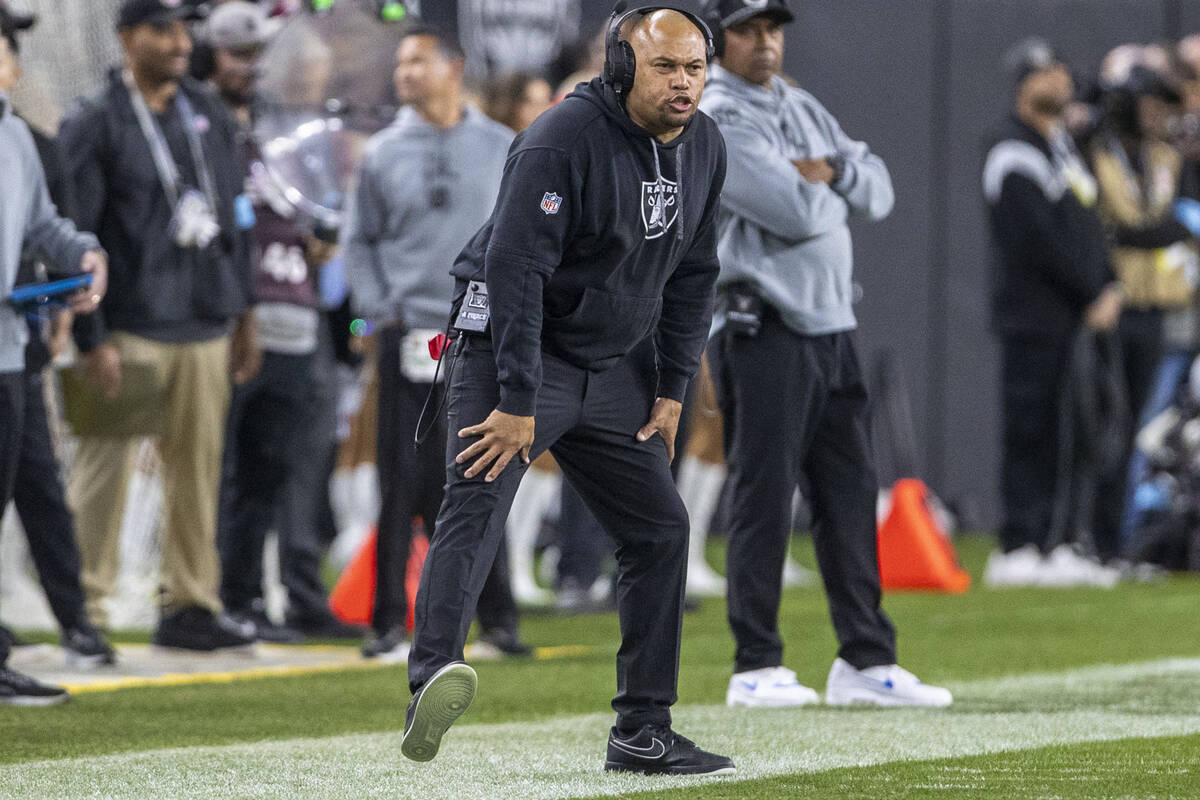 Raiders head coach Antonio Pierce reacts to a play during the first half of an NFL game against ...