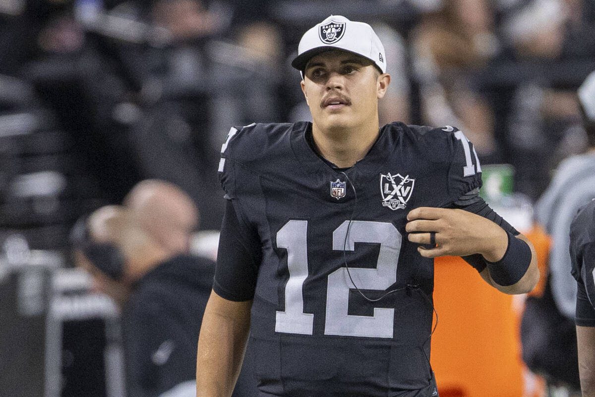 Raiders quarterback Aidan O'Connell (12) on the sideline during the first half of an NFL game a ...