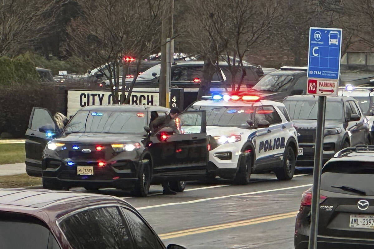 Emergency vehicles are parked outside the Abundant Life Christian School in Madison, Wis., wher ...