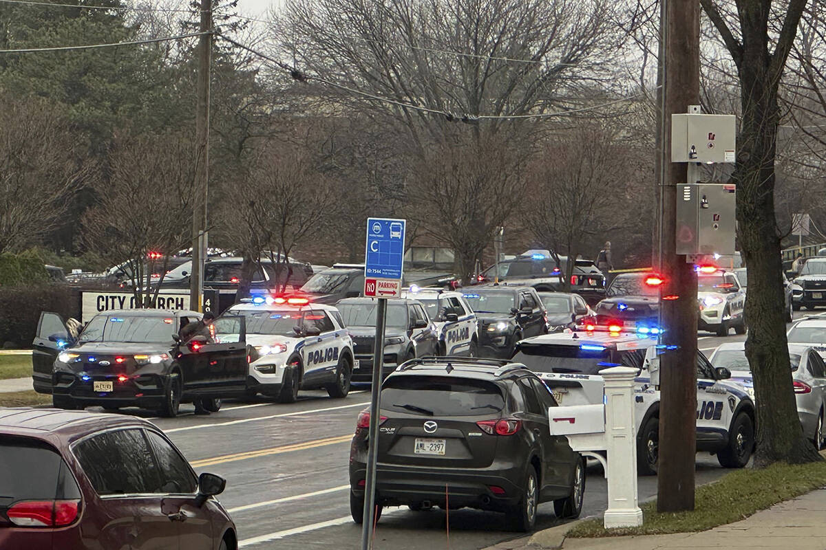 Emergency vehicles are parked outside the Abundant Life Christian School in Madison, Wis., wher ...