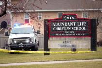 Emergency vehicles are parked outside the Abundant Life Christian School in Madison, Wis., foll ...