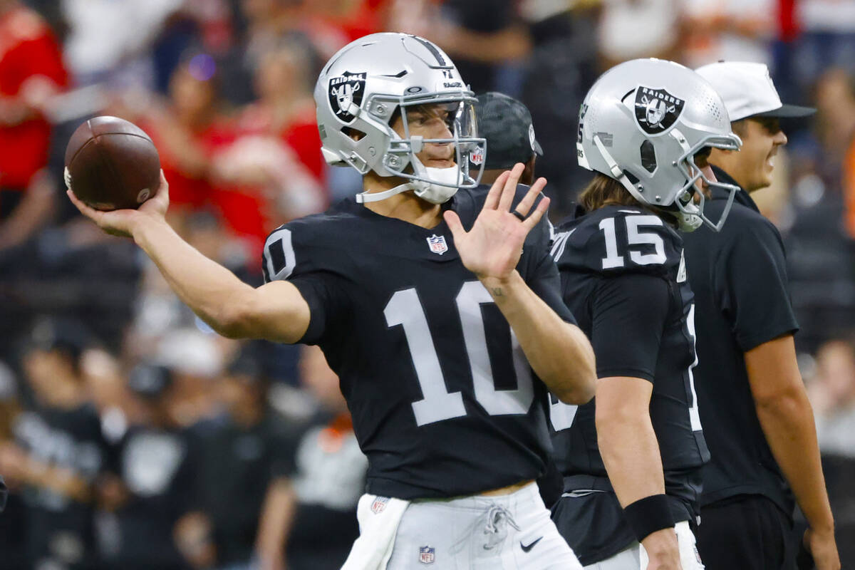 Raiders quarterback Desmond Ridder (10) throws the ball as he warms up prior to an NFL game aga ...