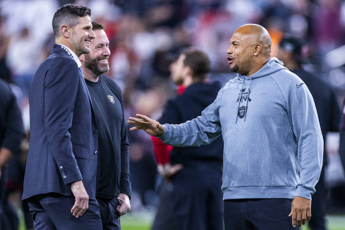 Raiders Head Coach Antonio Pierce talks with others on the field during warm ups before the fir ...