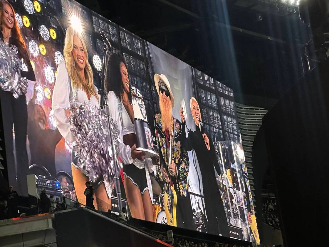 Billy F. Gibbons is shown with Raiderettes and in-game announcer Sibley Scoles, who serenaded G ...