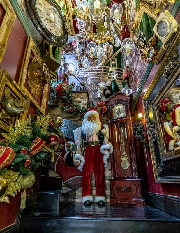 The stairwell featured gold-gilded music notes, floating candlesticks in glass orbs and bronze ...