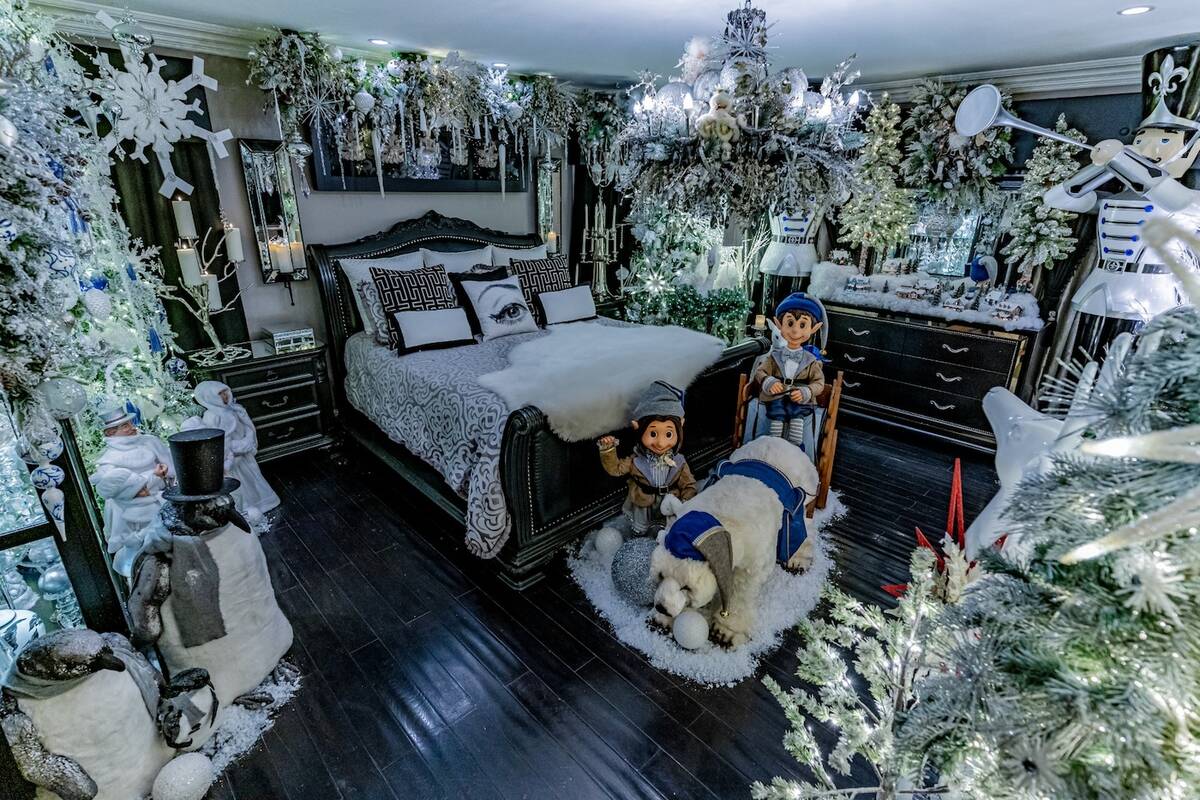 A bedroom showcased 10 flocked trees, animatronic polar bears, white garlands and lights. A thi ...