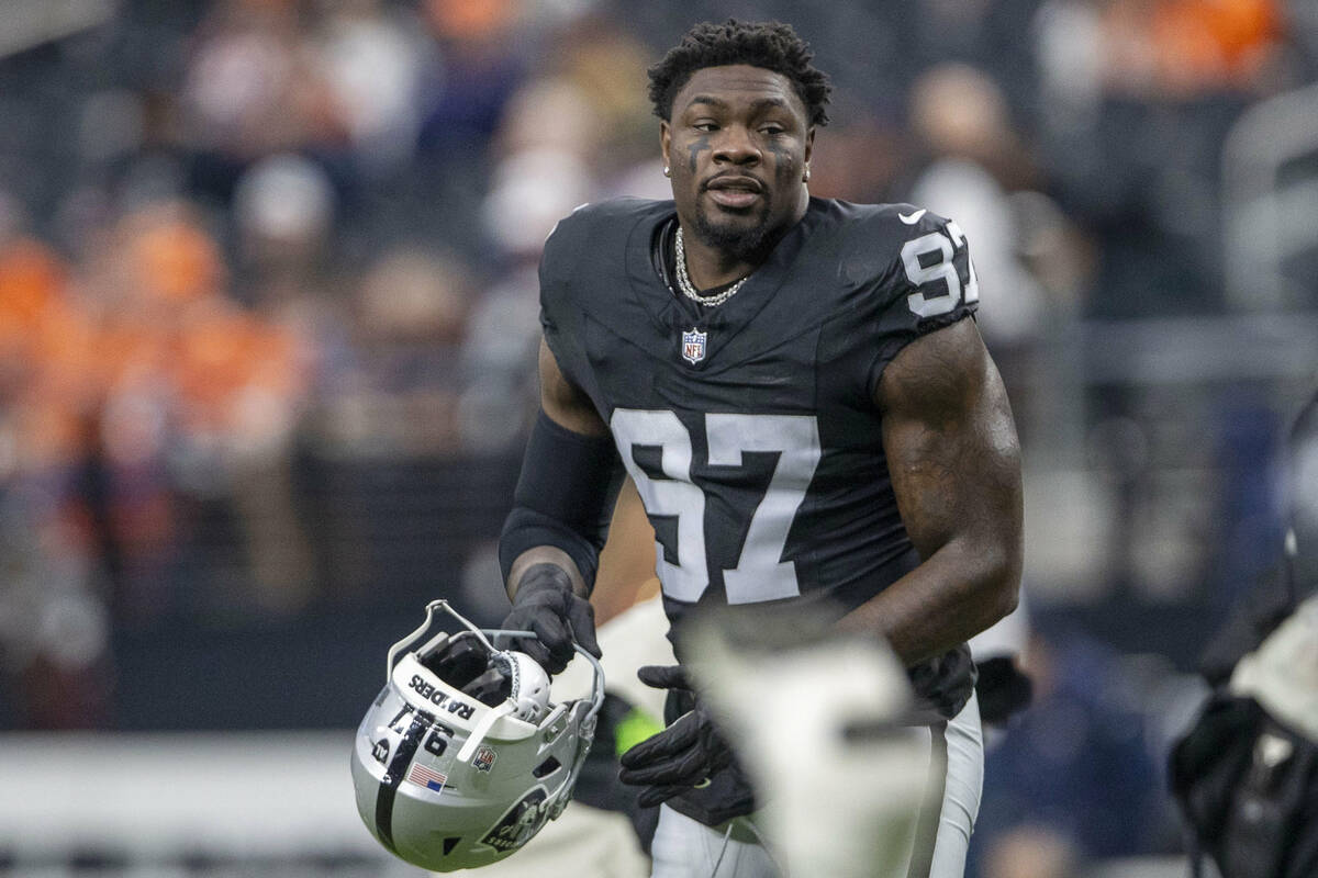 Raiders defensive end Janarius Robinson (97) stretches before an NFL game against the Denver Br ...