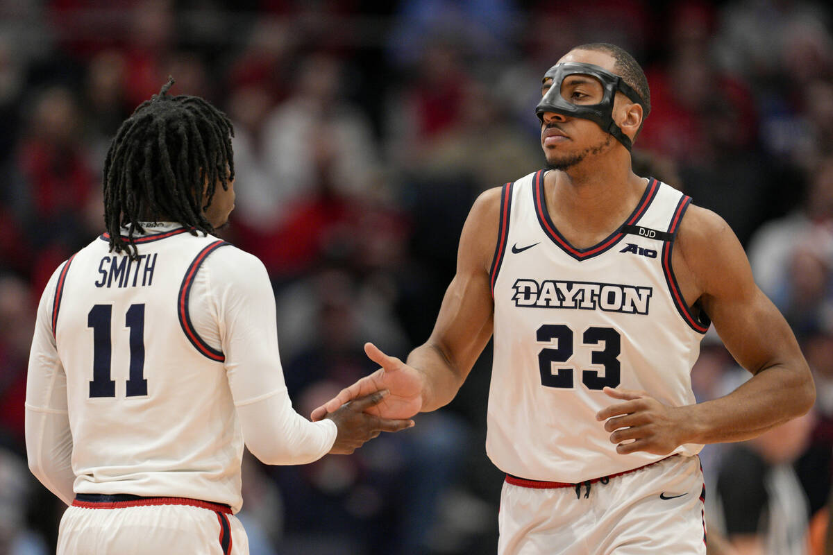 Dayton's Zed Key (23) celebrates with teammate Malachi Smith (11) during the first half of an N ...