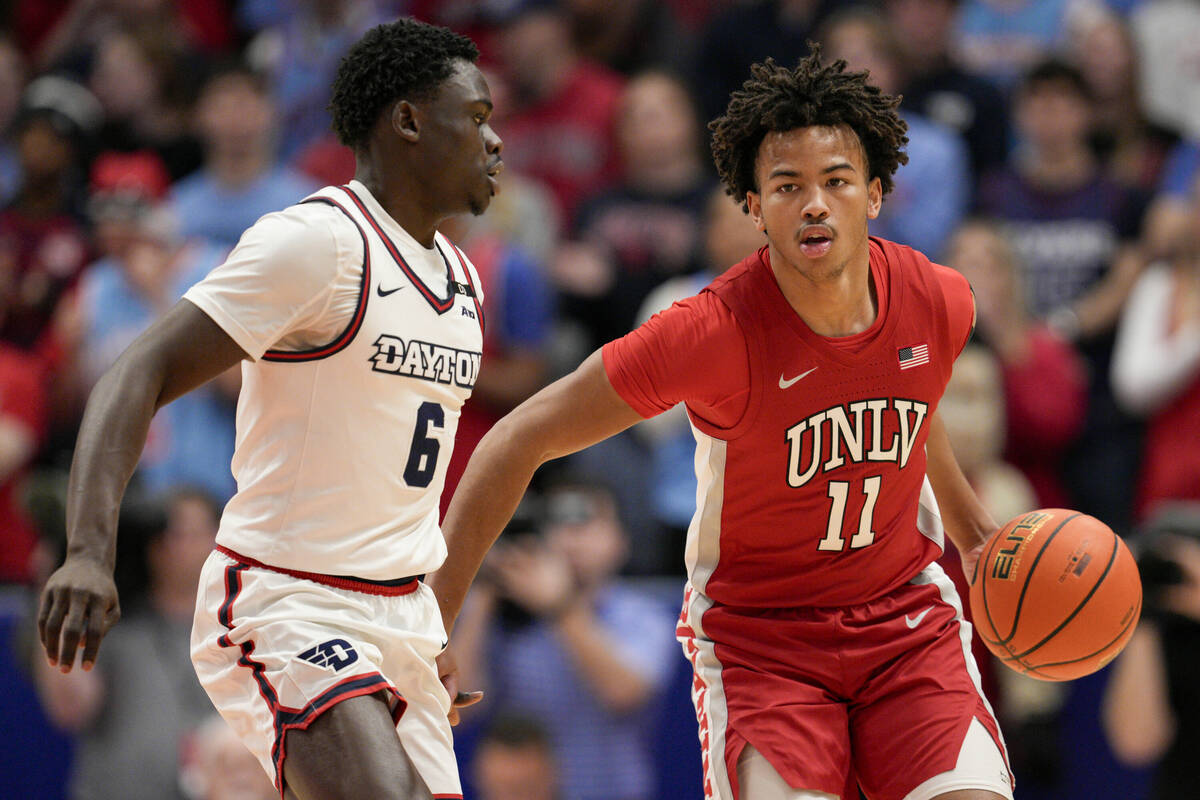 UNLV guard Dedan Thomas Jr. (11) dribbles against Dayton's Enoch Cheeks (6) during the first ha ...