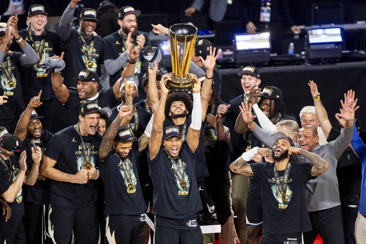 Milwaukee Bucks forward Giannis Antetokounmpo hoists the NBA Cup trophy after winning the NBA C ...