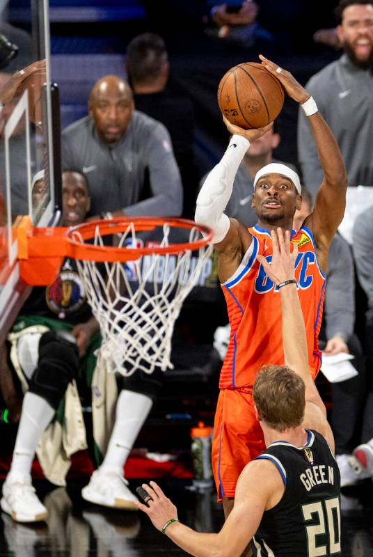 Oklahoma City Thunder guard Shai Gilgeous-Alexander (2) attempts a three-point shot over Milwau ...