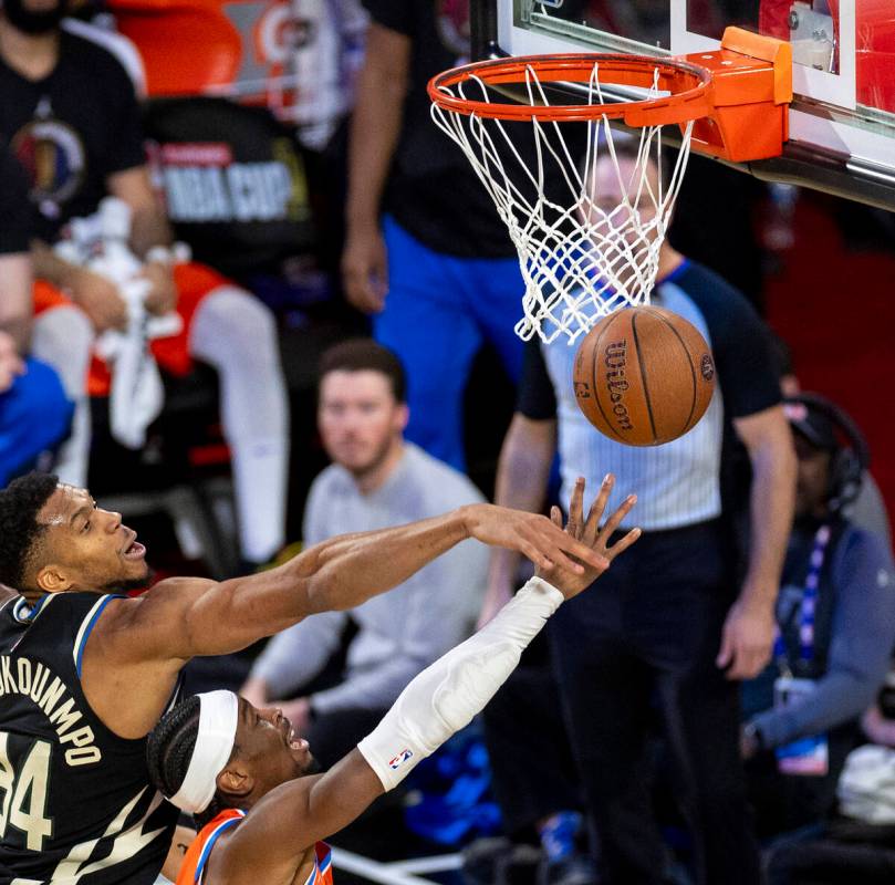 Milwaukee Bucks forward Giannis Antetokounmpo, left, blocks a shot by Oklahoma City Thunder gua ...