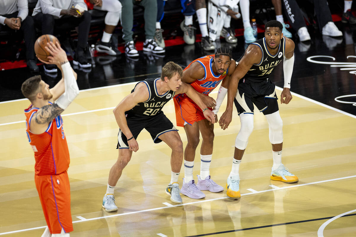 Milwaukee Bucks guard AJ Green (20), Oklahoma City Thunder guard Aaron Wiggins (21) and Milwauk ...