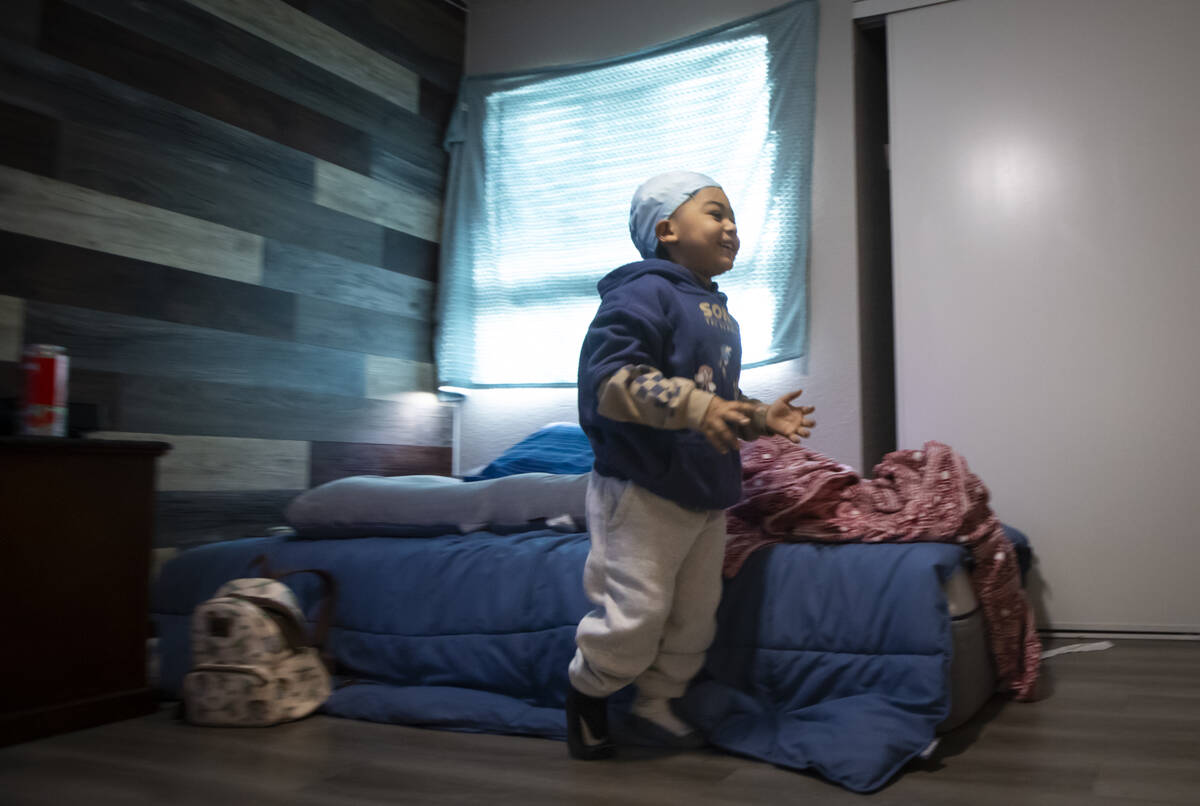 Carmelo Crews, 3, smiles while running past one of the mattresses that was donated to the famil ...