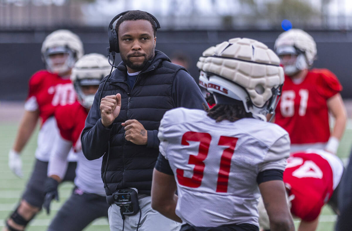 UNLV offensive coordinator Brennan Marion dances as his players stretch during spring football ...