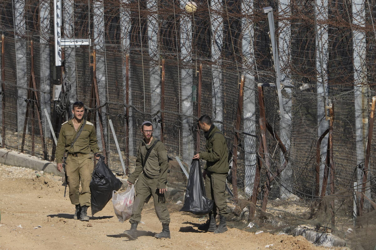 Israeli soldiers clean along the so-called Alpha Line that separates the Israeli-controlled Gol ...