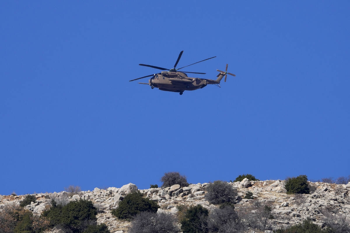 An Israeli Air Force Black Hawk helicopter flies over Mount Hermon near the so-called Alpha Lin ...