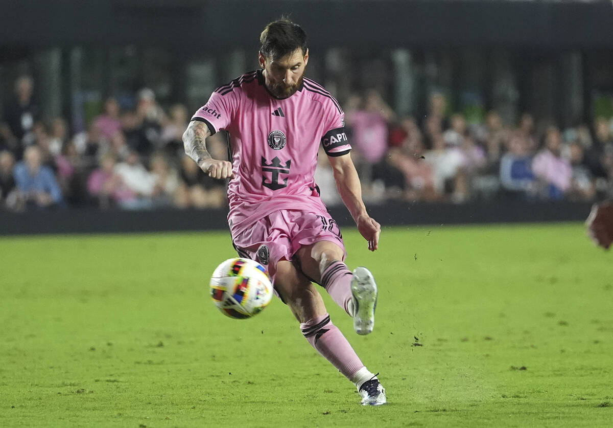 Inter Miami forward Lionel Messi, left, kicks the ball during the second half of their MLS play ...