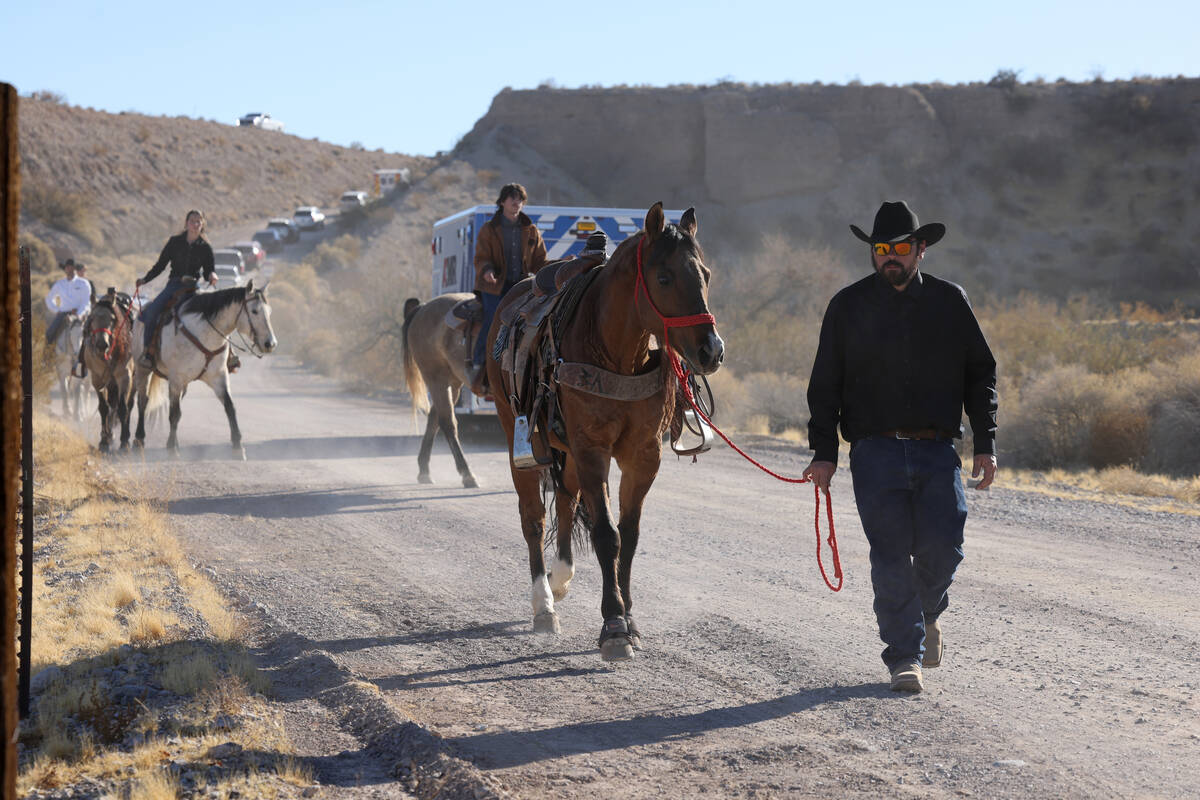 David Paldi, a friend of Las Vegas police officer Colton Pulsipher, walks a riderless horse rep ...