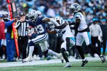 Dallas Cowboys running back Rico Dowdle (23) is hit by Carolina Panthers safeties Xavier Woods ...