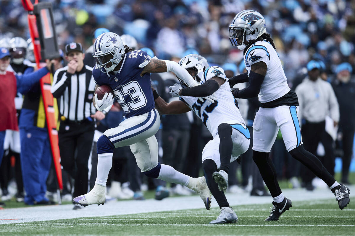 Dallas Cowboys running back Rico Dowdle (23) is hit by Carolina Panthers safeties Xavier Woods ...