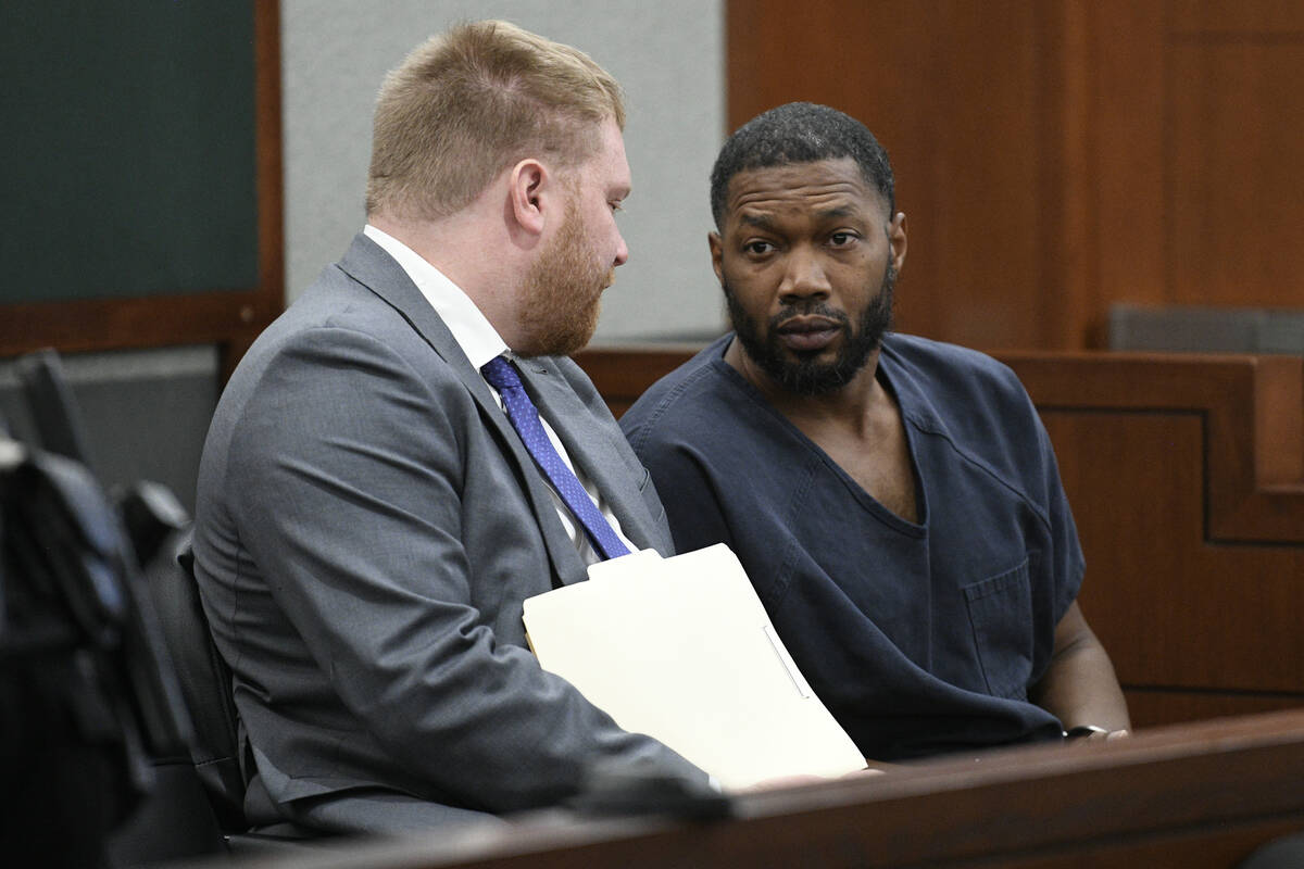 Antwone Washington talks with attorney Tyler Gaston before his arraignment Wednesday, December ...