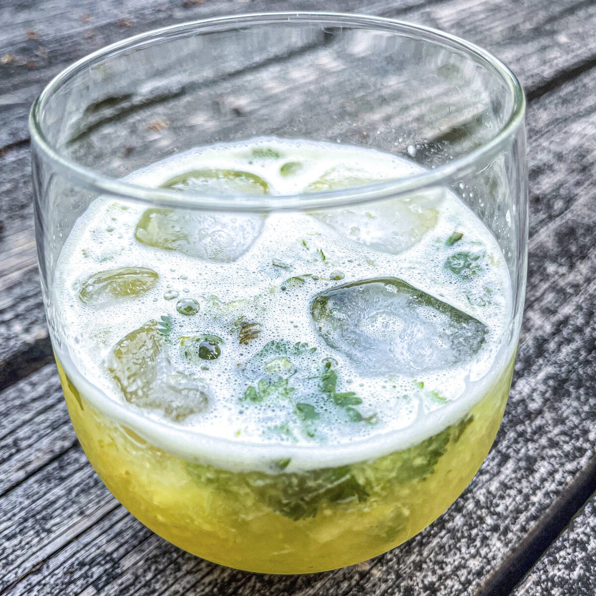 This 2021 image shows a Tepache mocktail made with cilantro simple syrup and fresh cilantro. (S ...