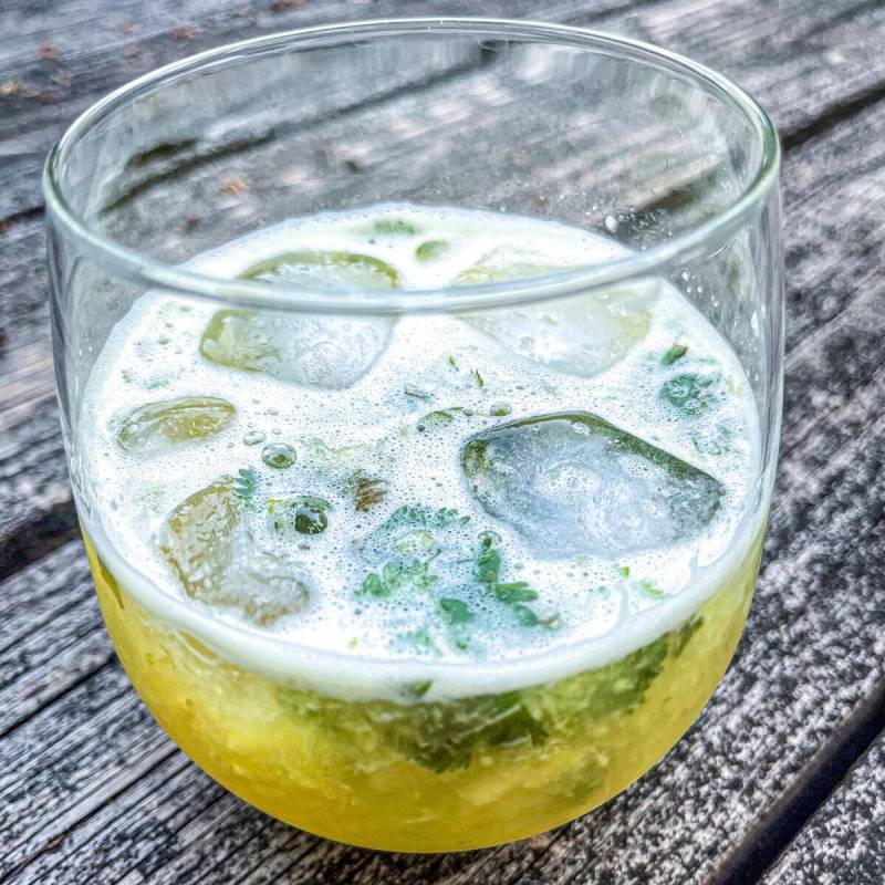 This 2021 image shows a Tepache mocktail made with cilantro simple syrup and fresh cilantro. (S ...