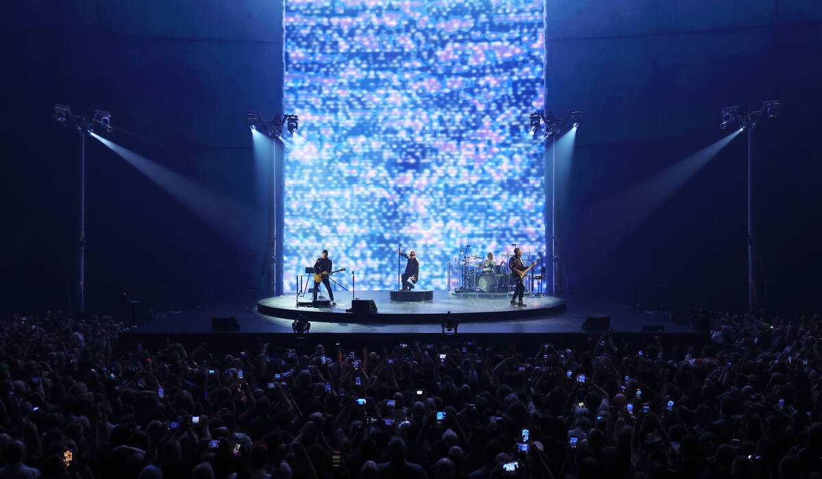 Bono, The Edge, Adam Clayton and Bram van den Berg of U2 perform during opening night of U2:UV ...