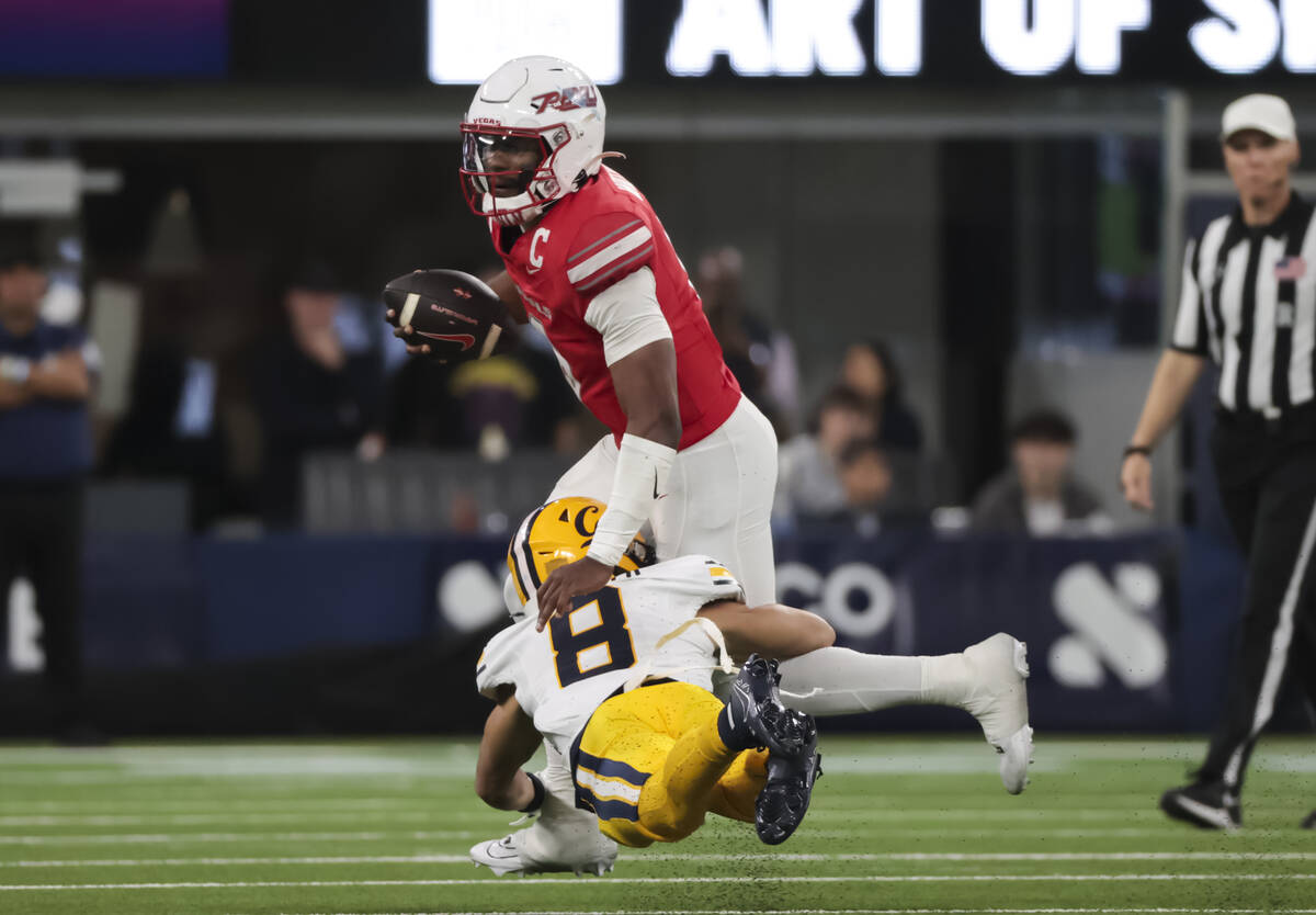 UNLV quarterback Hajj-Malik Williams (6) gets tackled by Cal defensive back Jasiah Wagoner (8) ...